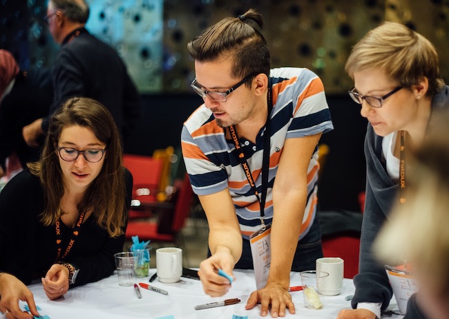 3 people in conversation during a workshop
